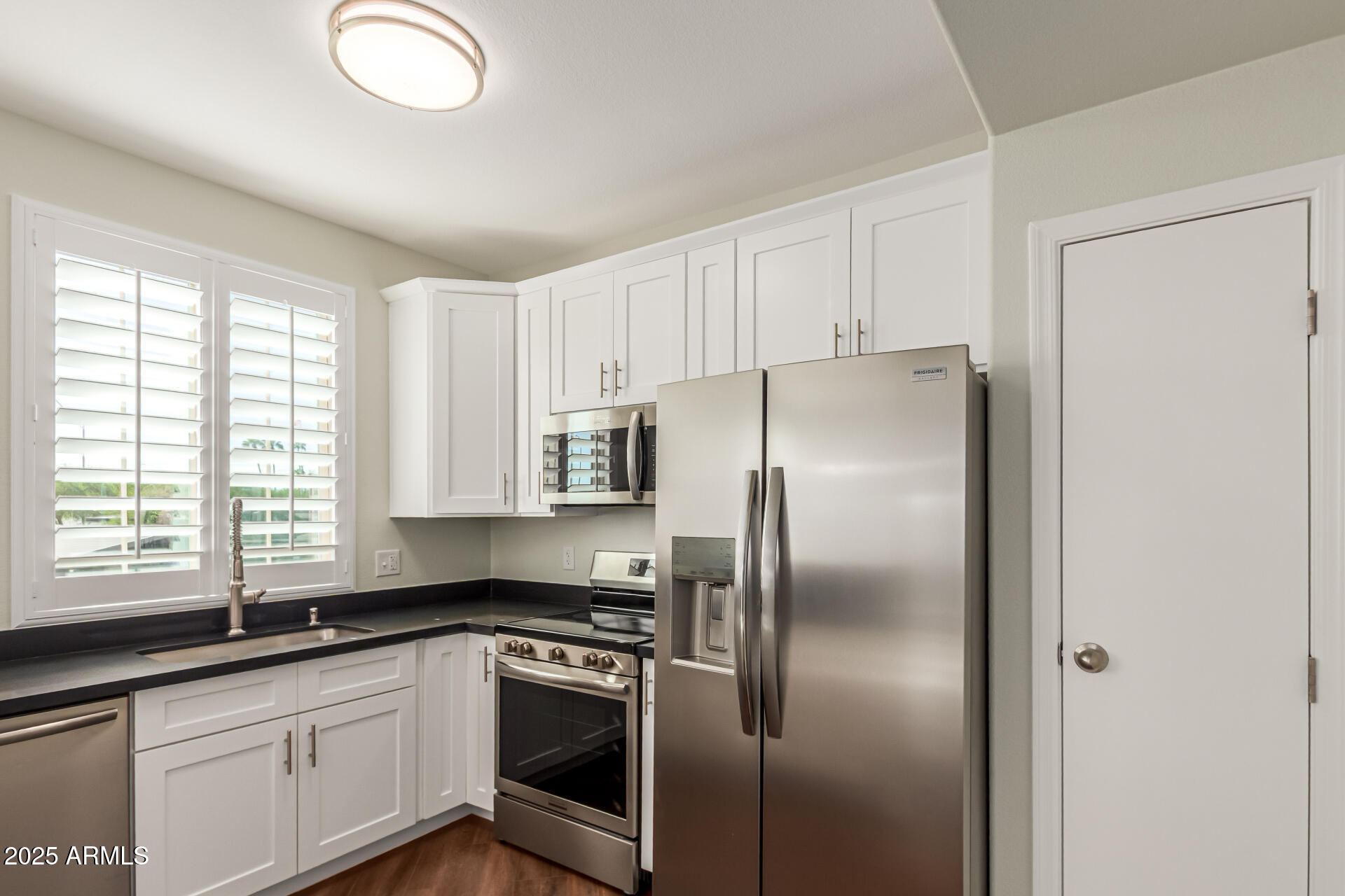 1720 East Thunderbird Road, Unit 2125 Phoenix, AZ 85022 - Photo 11 of 37 a kitchen with a refrigerator sink and cabinets