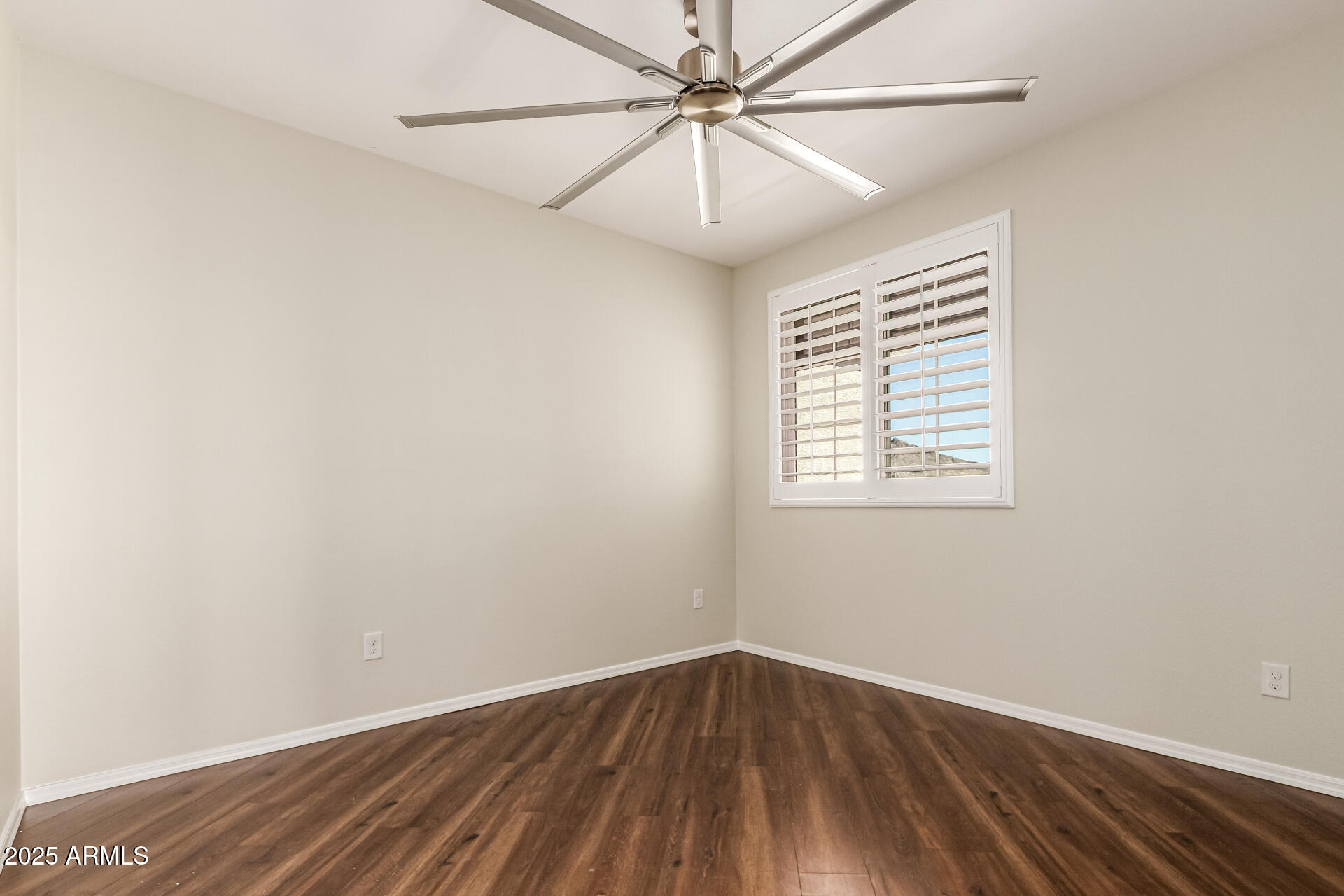 1720 East Thunderbird Road, Unit 2125 Phoenix, AZ 85022 - Photo 16 of 37 an empty room with wooden floor fan and windows