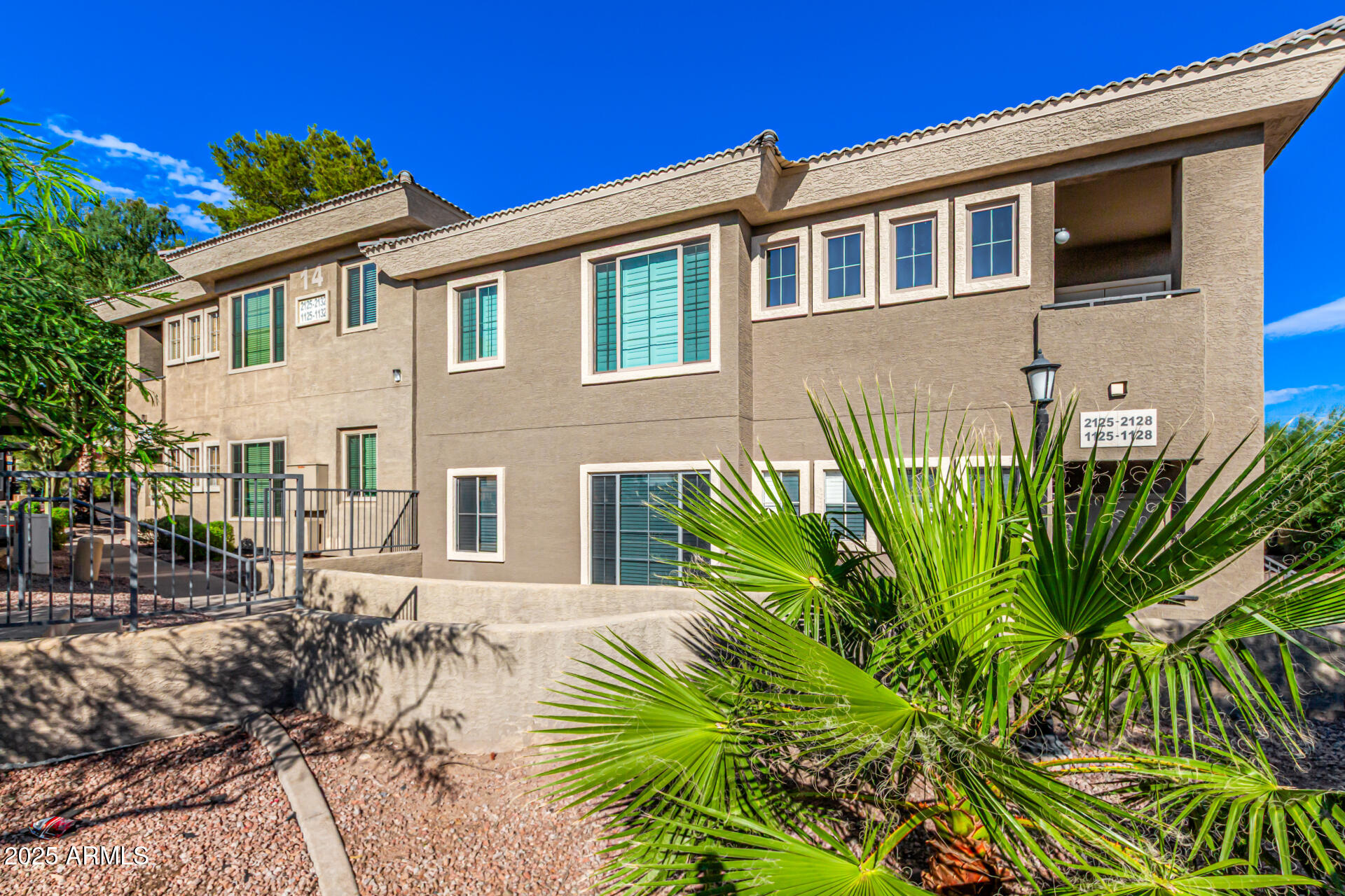 1720 East Thunderbird Road, Unit 2125 Phoenix, AZ 85022 - Photo 25 of 37 a front view of a house with a garden
