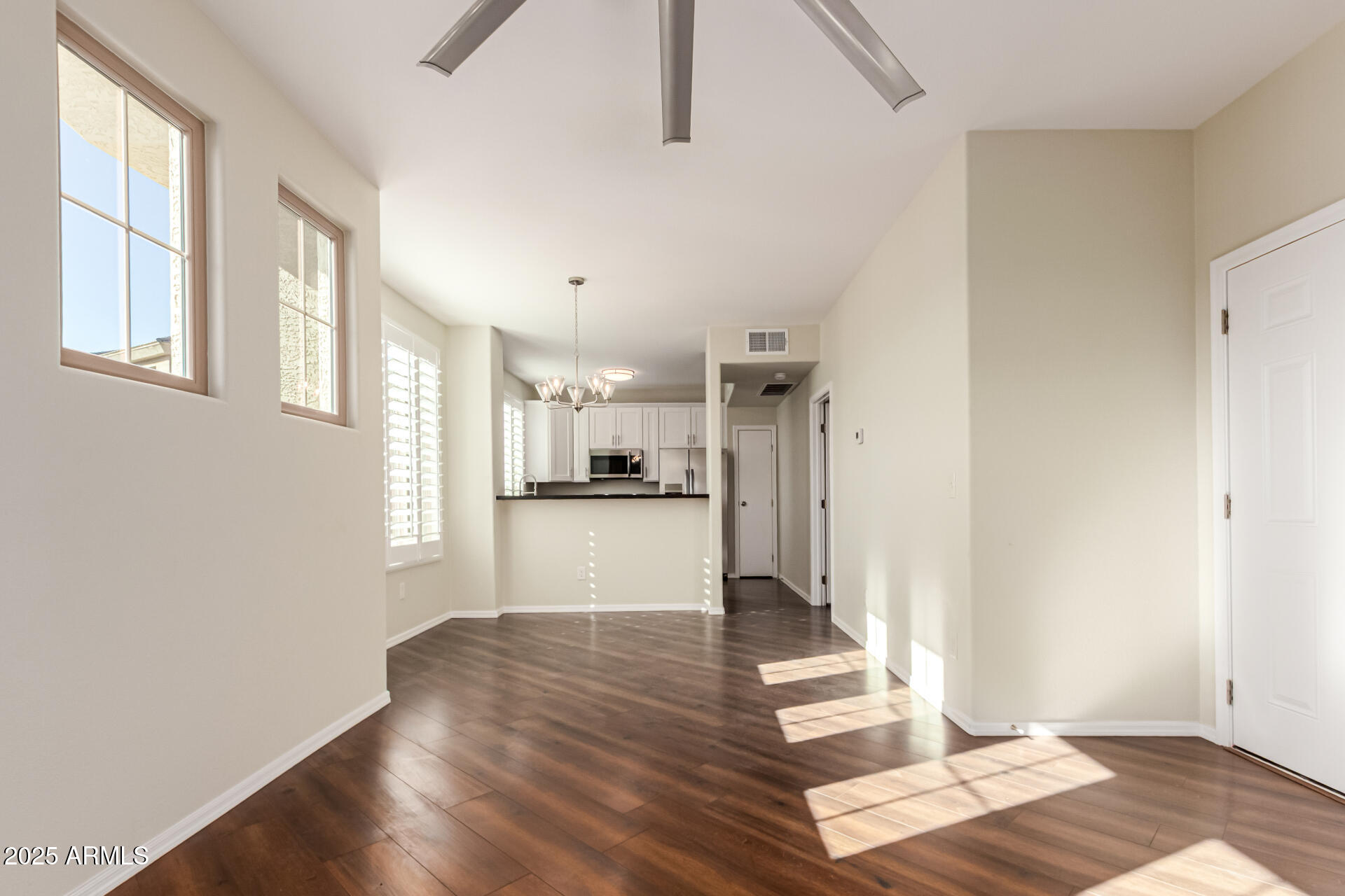 1720 East Thunderbird Road, Unit 2125 Phoenix, AZ 85022 - Photo 3 of 37 a view of kitchen and hall with wooden floor