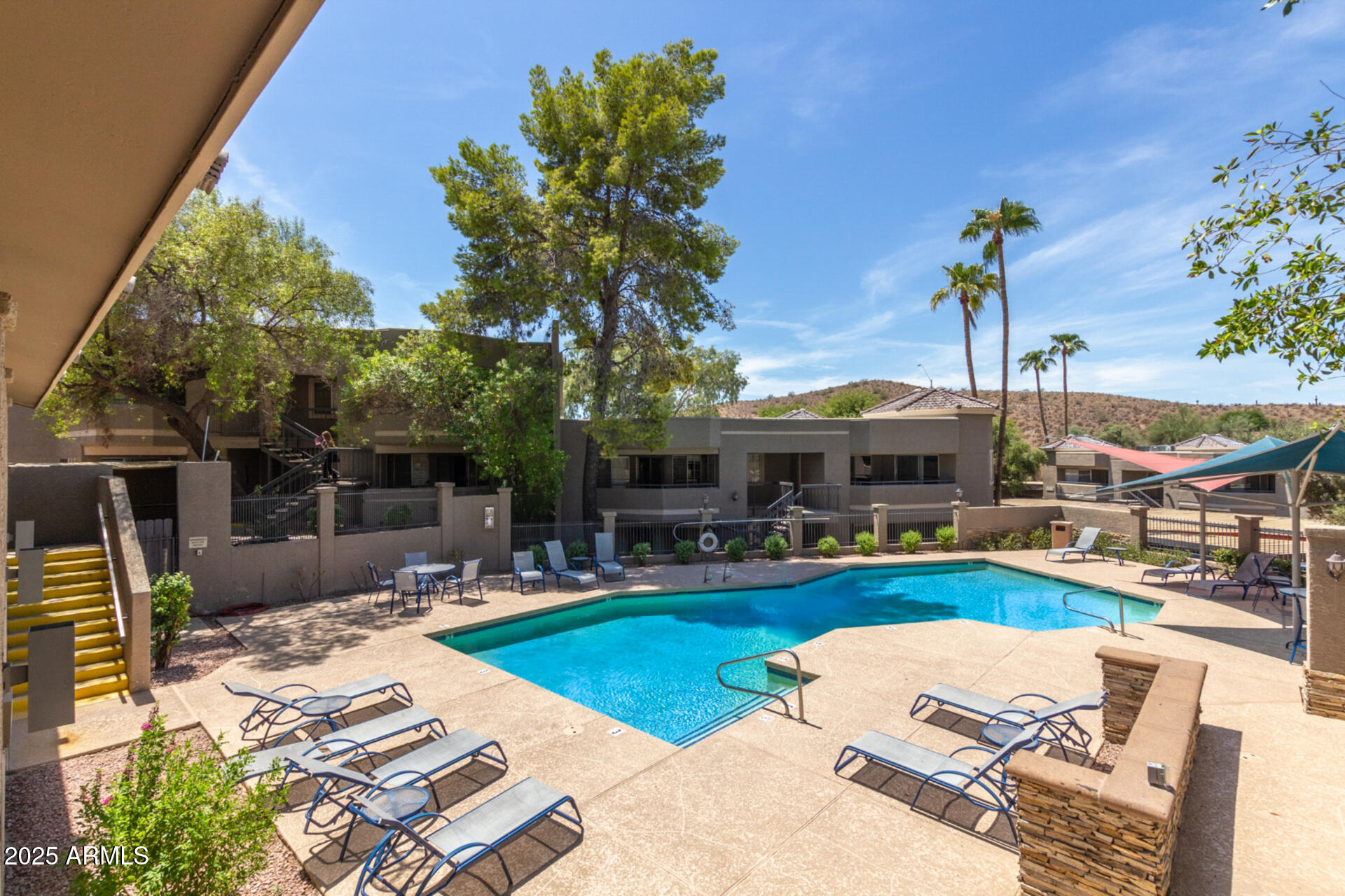 1720 East Thunderbird Road, Unit 2125 Phoenix, AZ 85022 - Photo 34 of 37 a view of a backyard with couches potted plants and a large tree