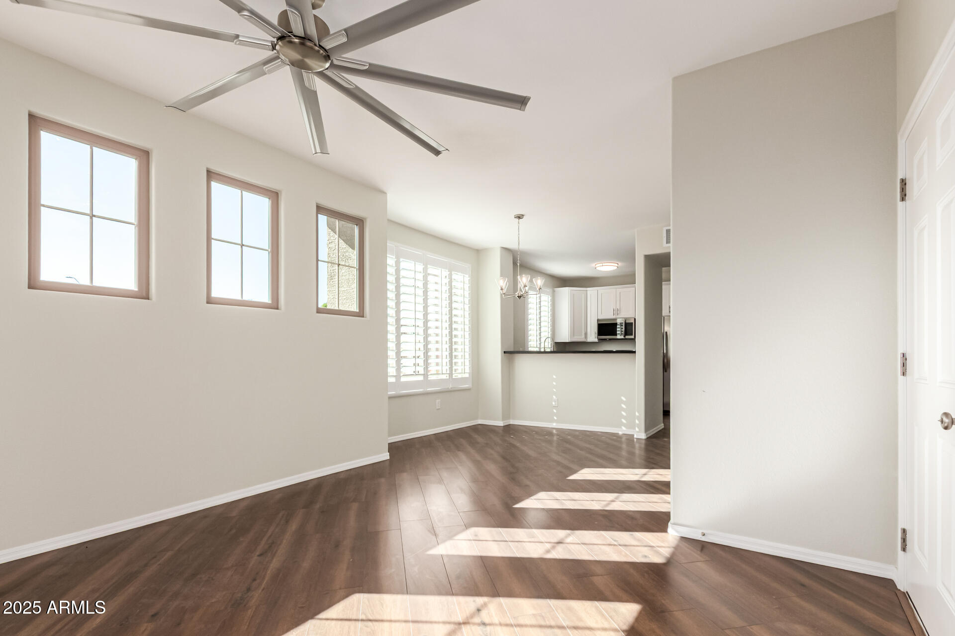 1720 East Thunderbird Road, Unit 2125 Phoenix, AZ 85022 - Photo 5 of 37 a view of an empty room with wooden floor and a window