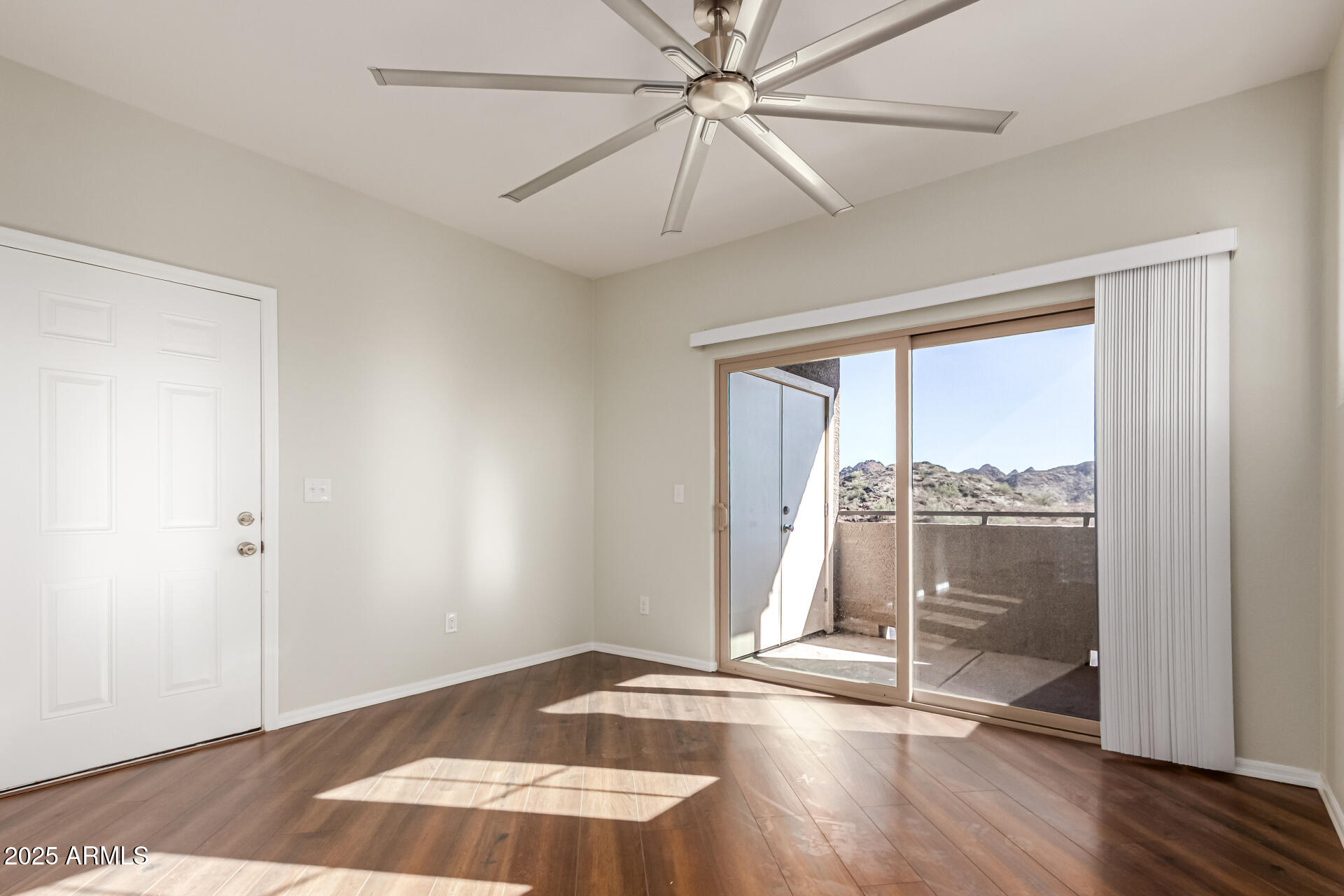 1720 East Thunderbird Road, Unit 2125 Phoenix, AZ 85022 - Photo 6 of 37 a view of an empty room with wooden floor and a window