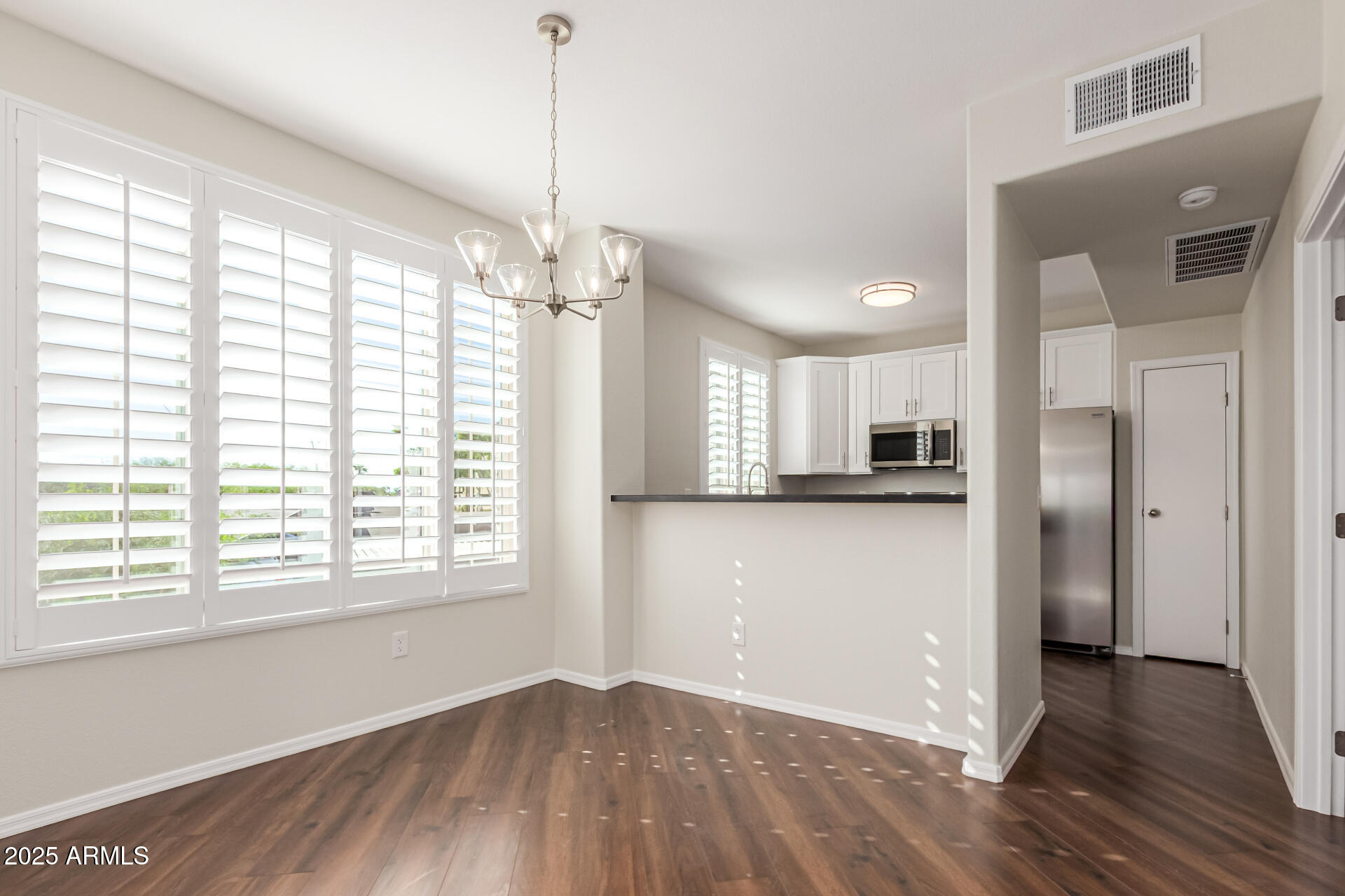 1720 East Thunderbird Road, Unit 2125 Phoenix, AZ 85022 - Photo 7 of 37 a view of a kitchen with a stove cabinets and a wooden floor