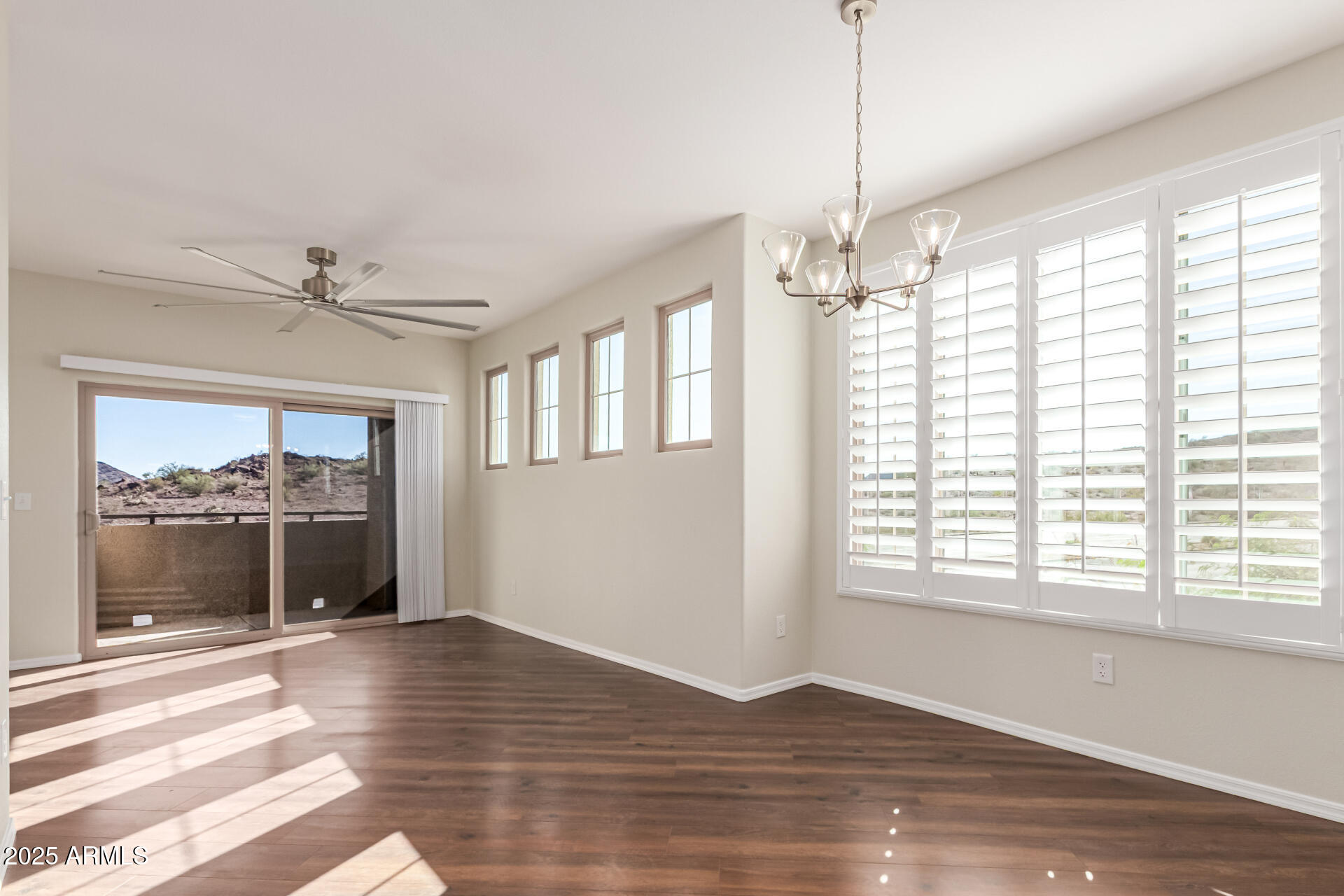 1720 East Thunderbird Road, Unit 2125 Phoenix, AZ 85022 - Photo 8 of 37 a view of an empty room with a window and wooden floor