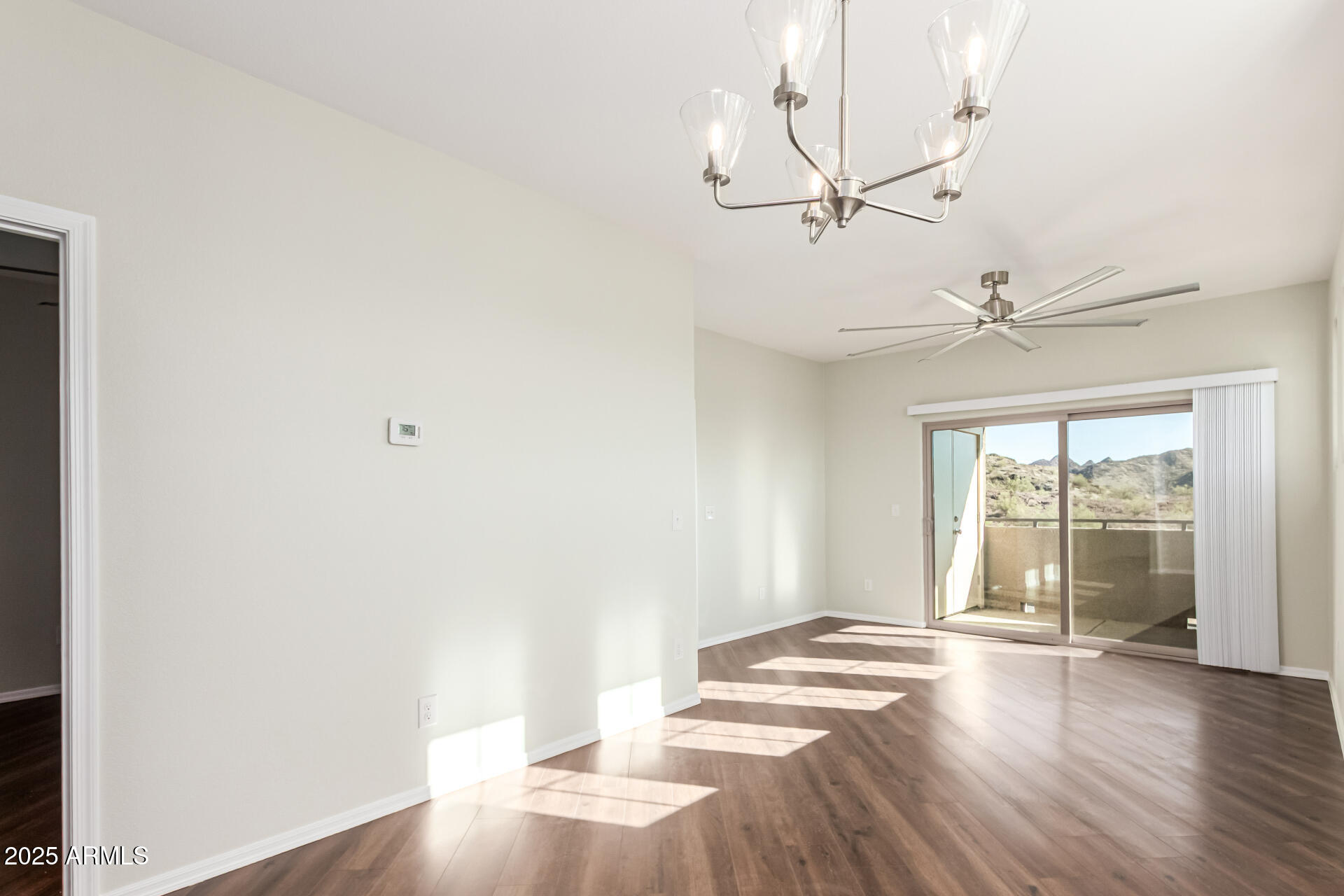 1720 East Thunderbird Road, Unit 2125 Phoenix, AZ 85022 - Photo 9 of 37 an empty room with wooden floor fan and windows