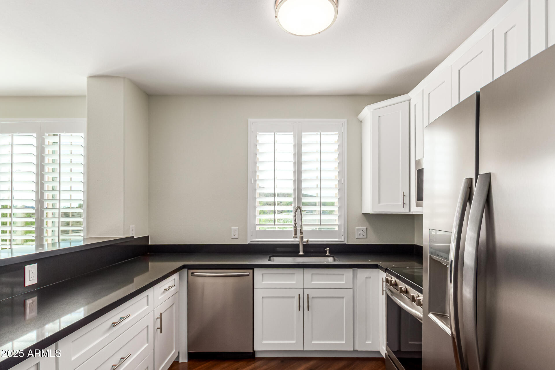 1720 East Thunderbird Road, Unit 2125 Phoenix, AZ 85022 - Photo 10 of 37 a kitchen with stainless steel appliances granite countertop a sink a stove and a refrigerator