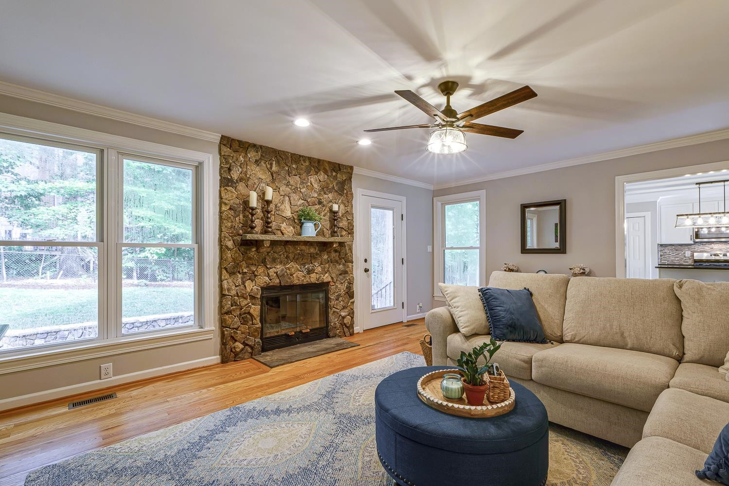 10009 Kilnstone Lane Raleigh, NC 27613 - Photo 4 of 15 The family room has a gorgeous STACK STONE FIREPLACE and lots of room for relaxing & entertaining. The gleaming HARDWOODS are in the dining room too and also extend up the staircase and down the second-floor hallway. Family Room