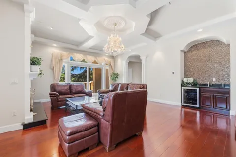 a living room with furniture a window and wooden floor