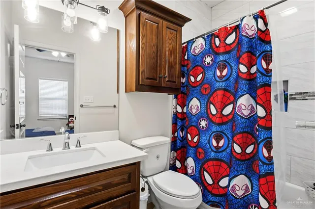 a bathroom with a sink toilet and shower