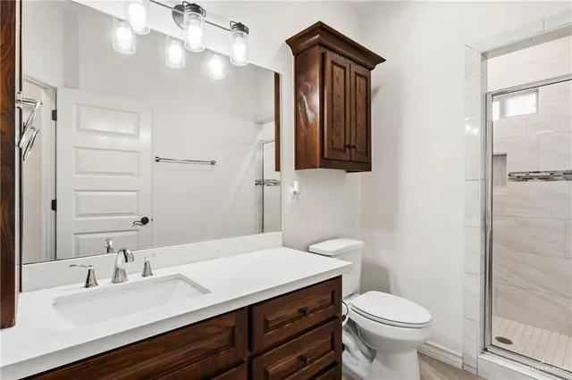 a bathroom with a sink a toilet and mirror