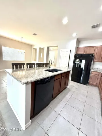 a kitchen with granite countertop a sink and a stove top oven