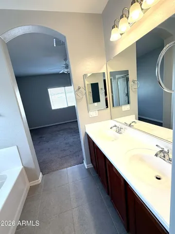 a bathroom with a sink a vanity and mirror
