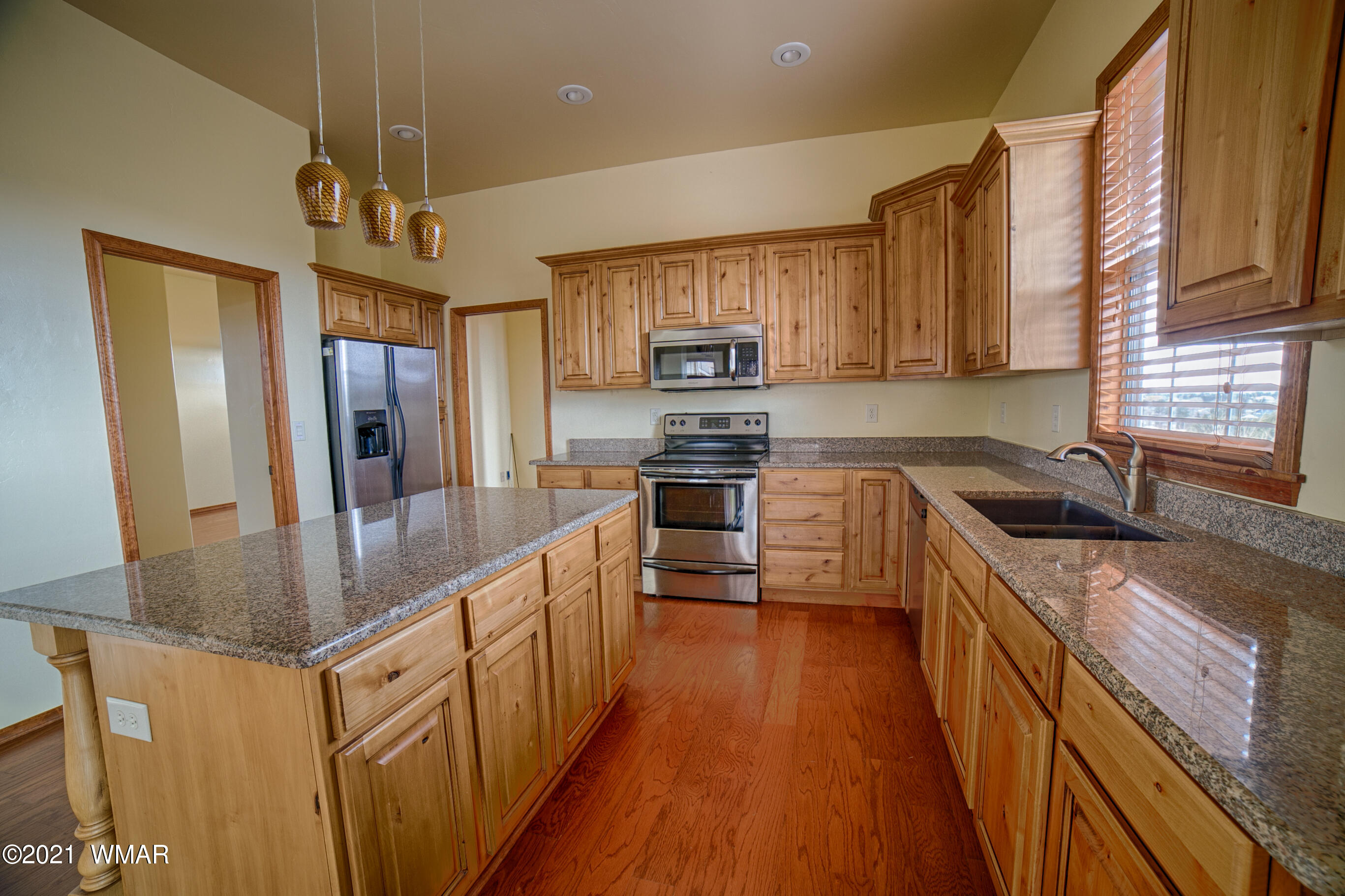 600 South Rock Ridge Drive Show Low, AZ 85901 - Photo 11 of 25 a kitchen with stainless steel appliances granite countertop a refrigerator a stove top oven a sink and dishwasher