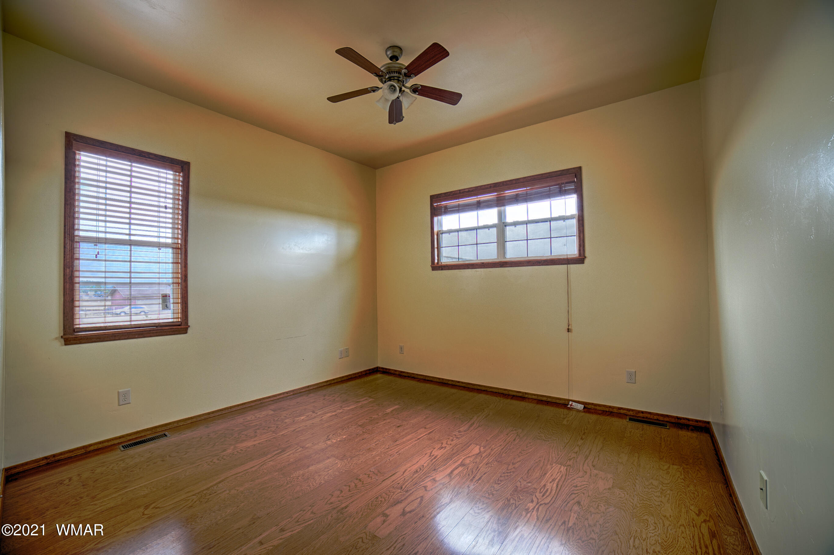 600 South Rock Ridge Drive Show Low, AZ 85901 - Photo 19 of 25 a view of empty room with wooden floor and fan