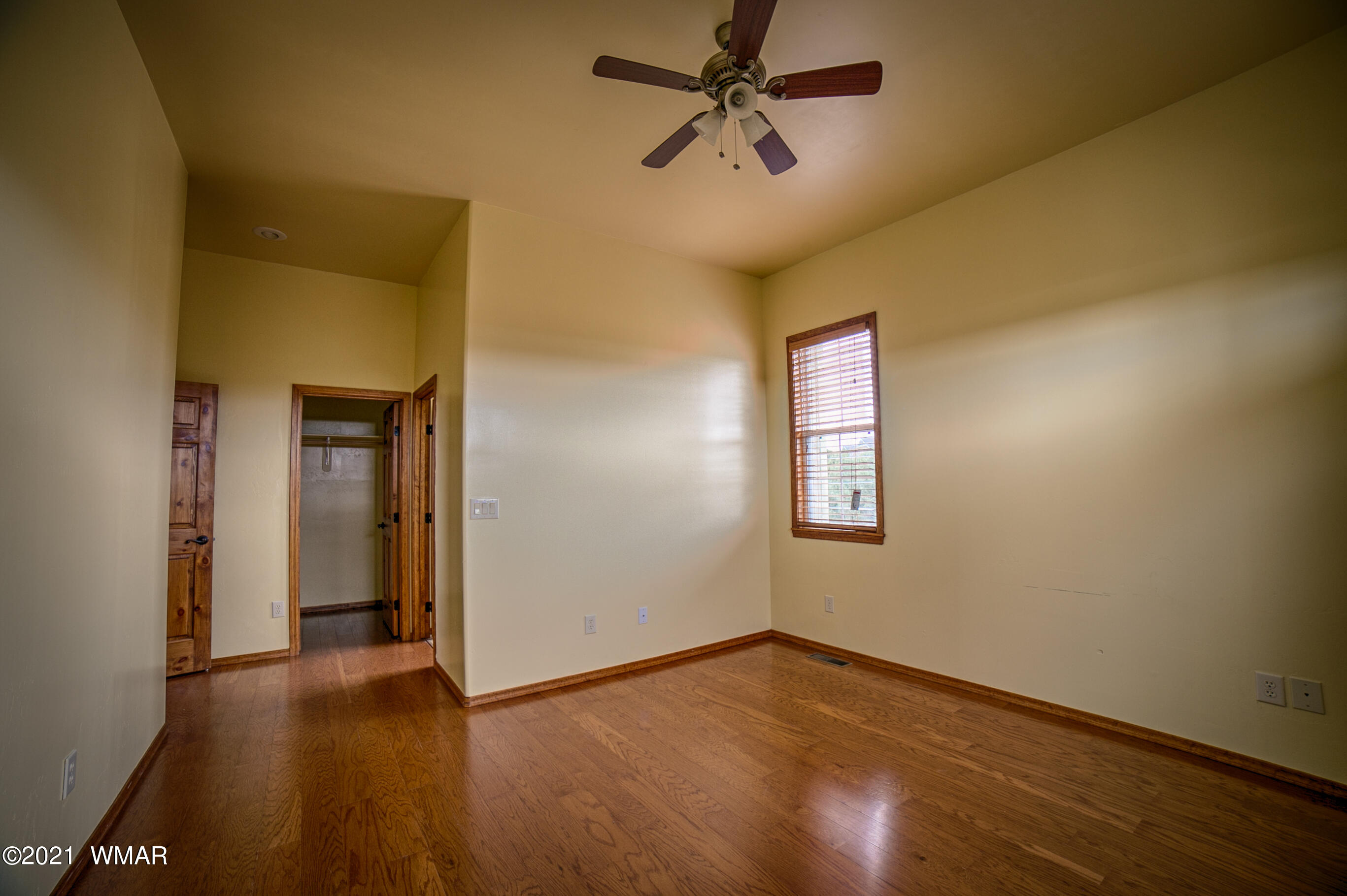 600 South Rock Ridge Drive Show Low, AZ 85901 - Photo 20 of 25 a view of empty room with wooden floor and fan