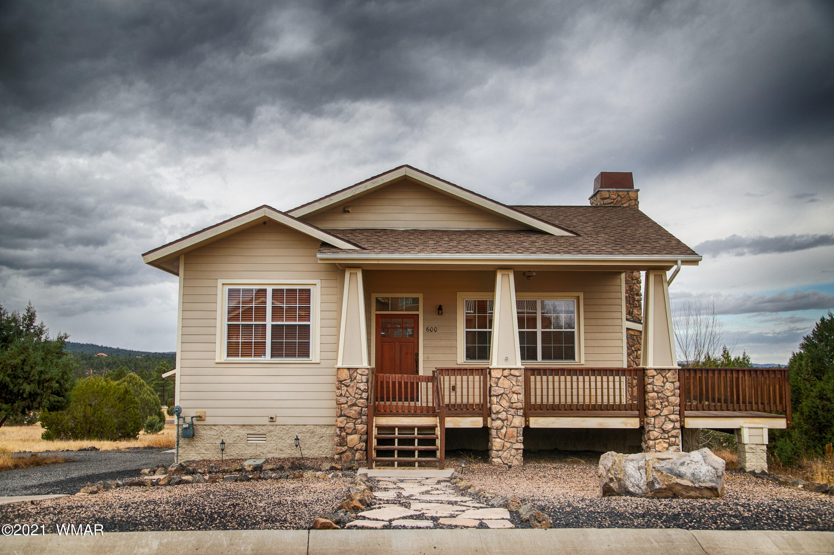 600 South Rock Ridge Drive Show Low, AZ 85901 - Photo 5 of 25 a front view of a house with a yard and balcony