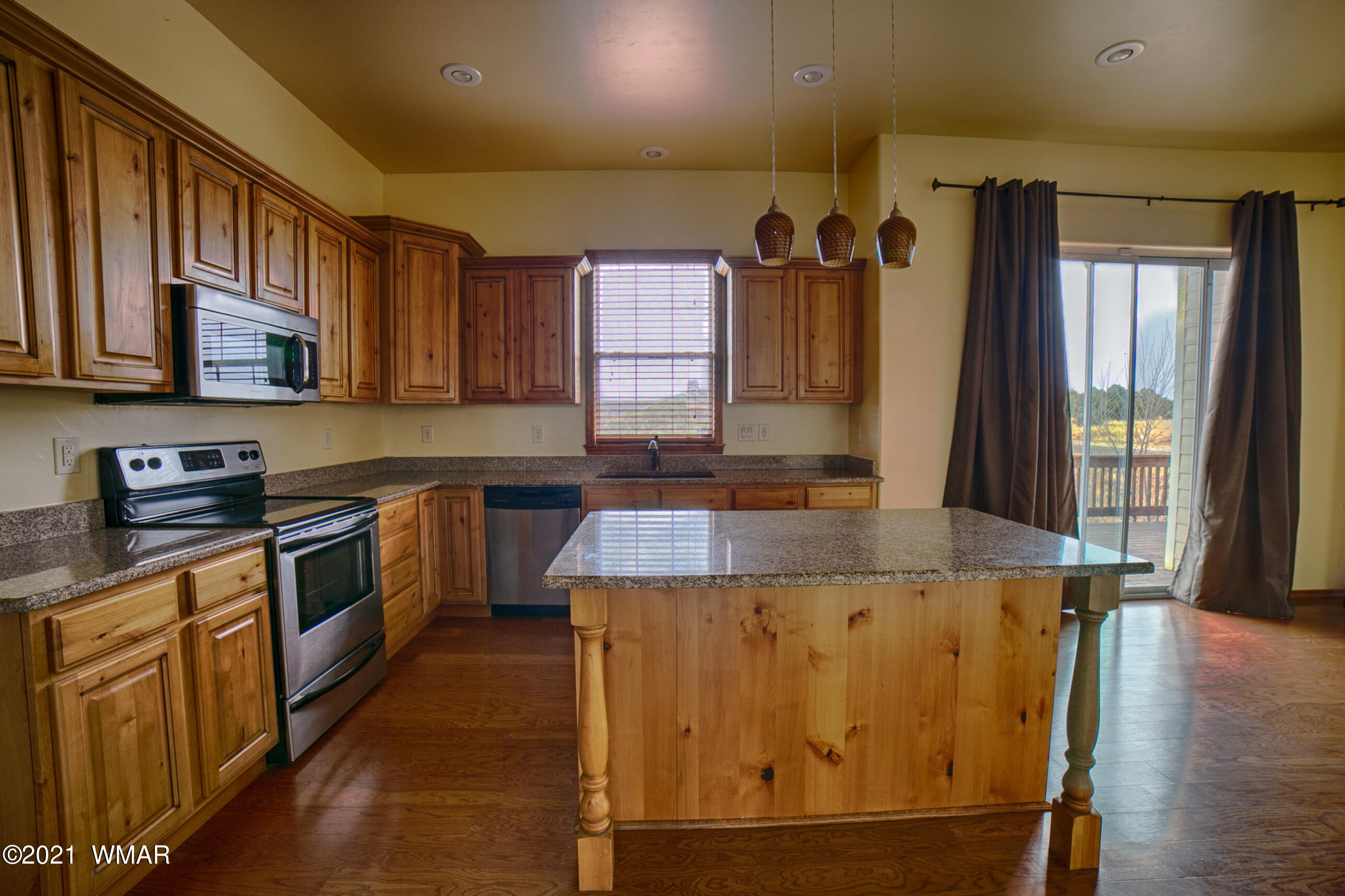 600 South Rock Ridge Drive Show Low, AZ 85901 - Photo 10 of 25 a kitchen with kitchen island granite countertop counter top space a sink stainless steel appliances and cabinets
