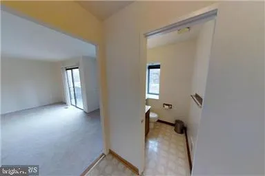 a view of a hallway with wooden shelves