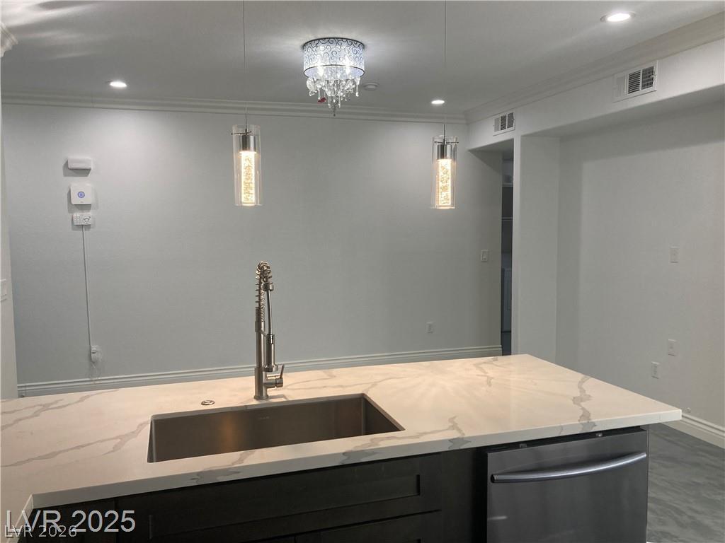 9050 West Warm Springs Road, Unit 1027 Las Vegas, NV 89148 - Photo 6 of 44 A well-appointed kitchen island offers generous counter space and a modern sink.