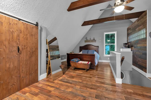 a bedroom with furniture and wooden floor