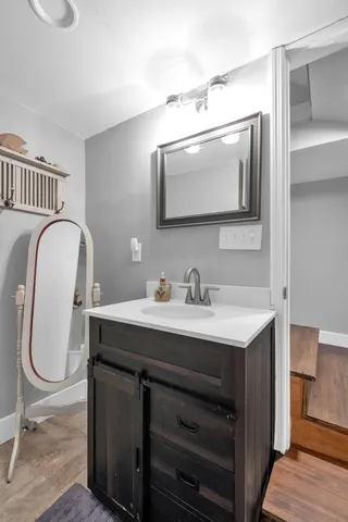 a bathroom with a sink a mirror and a toilet