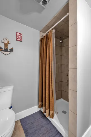 a bathroom with a shower and a toilet