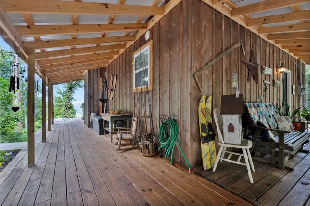 a view of outdoor space with wooden floor and seating