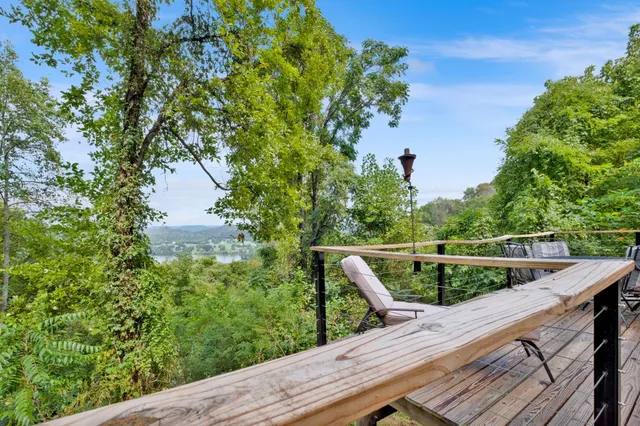 a view of a balcony with wooden floor and outdoor space
