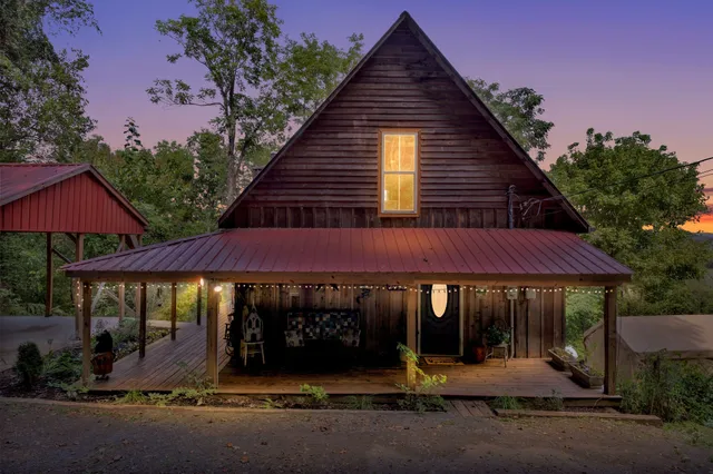 an aerial view of a house with a yard and lake view