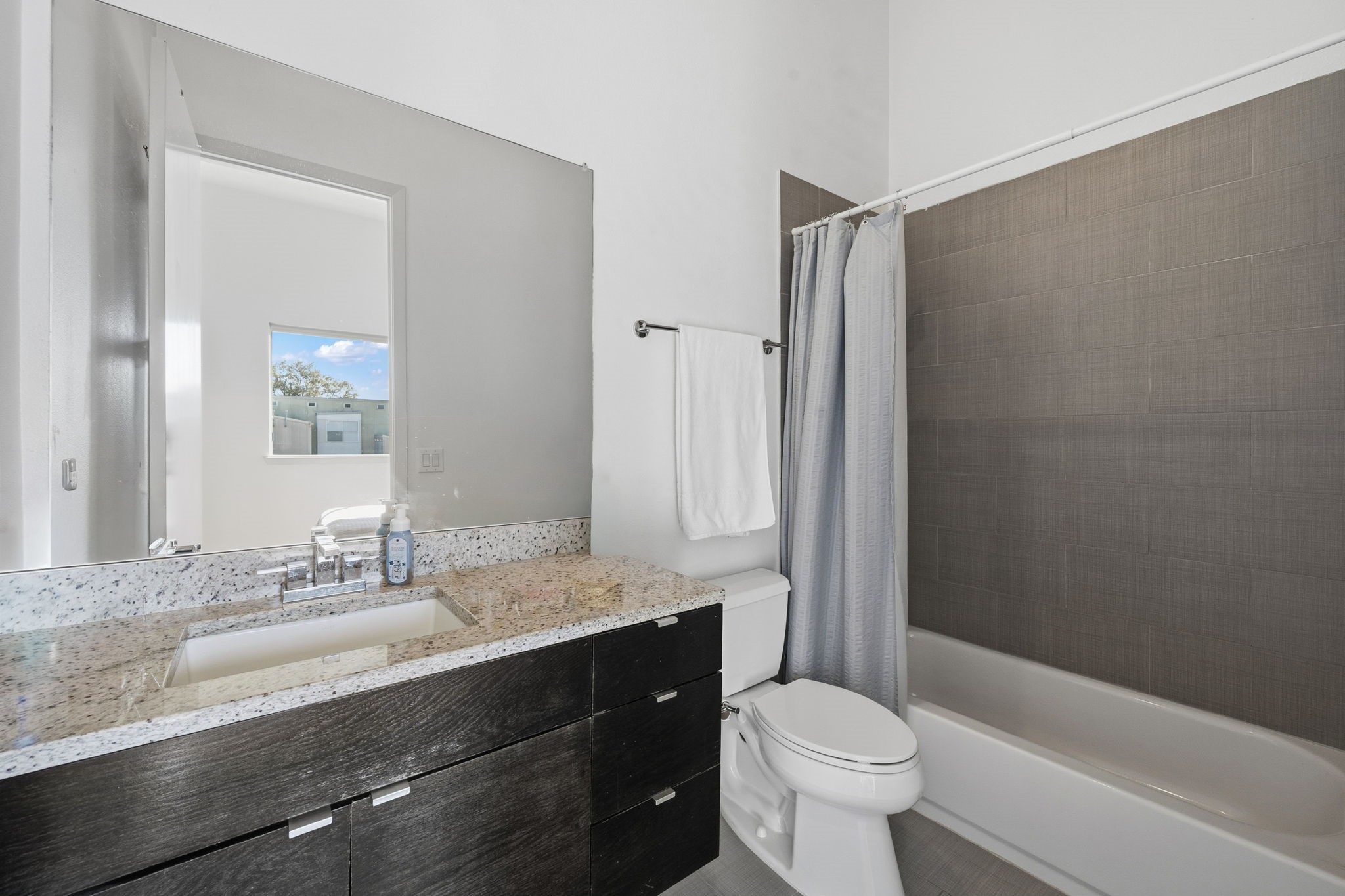 3302 Lake Street, Unit 3 Houston, TX 77098 - Photo 14 of 20 a bathroom with a sink a toilet a mirror and shower