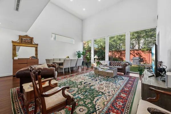 a living room with furniture and a floor to ceiling window