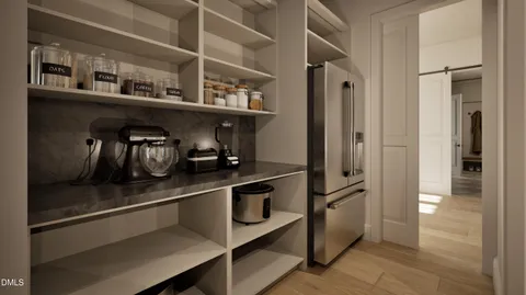 a kitchen with sink refrigerator and cabinets
