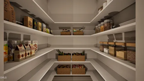 a kitchen with stainless steel appliances granite countertop a stove a refrigerator a kitchen island a couches and chairs with wooden floor