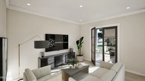 a living room with furniture and view of kitchen