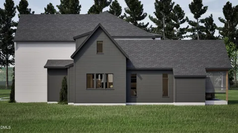 a view of a house with a yard and sitting area