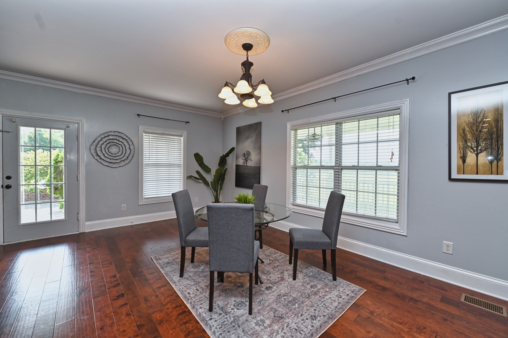 3356 Maxie Jones Road Springfield, TN 37172 - Photo 25 of 64 a dining room with wooden floor a chandelier a glass table and chairs