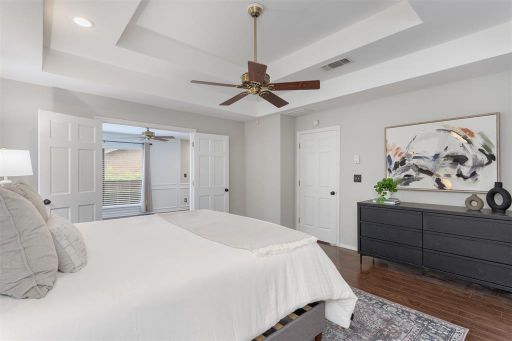 68 Legend Road Benbrook, TX 76132 - Photo 21 of 34 This primary bedroom is light and airy and also has engineered hardwood flooring.