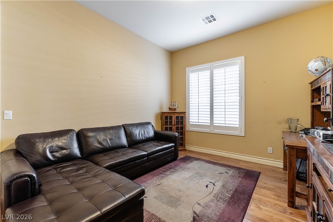 3661 Riley Ann Avenue Las Vegas, NV 89139 - Photo 26 of 42 Comfortable living area featuring rich hardwood floors and abundant natural light from wide windows.