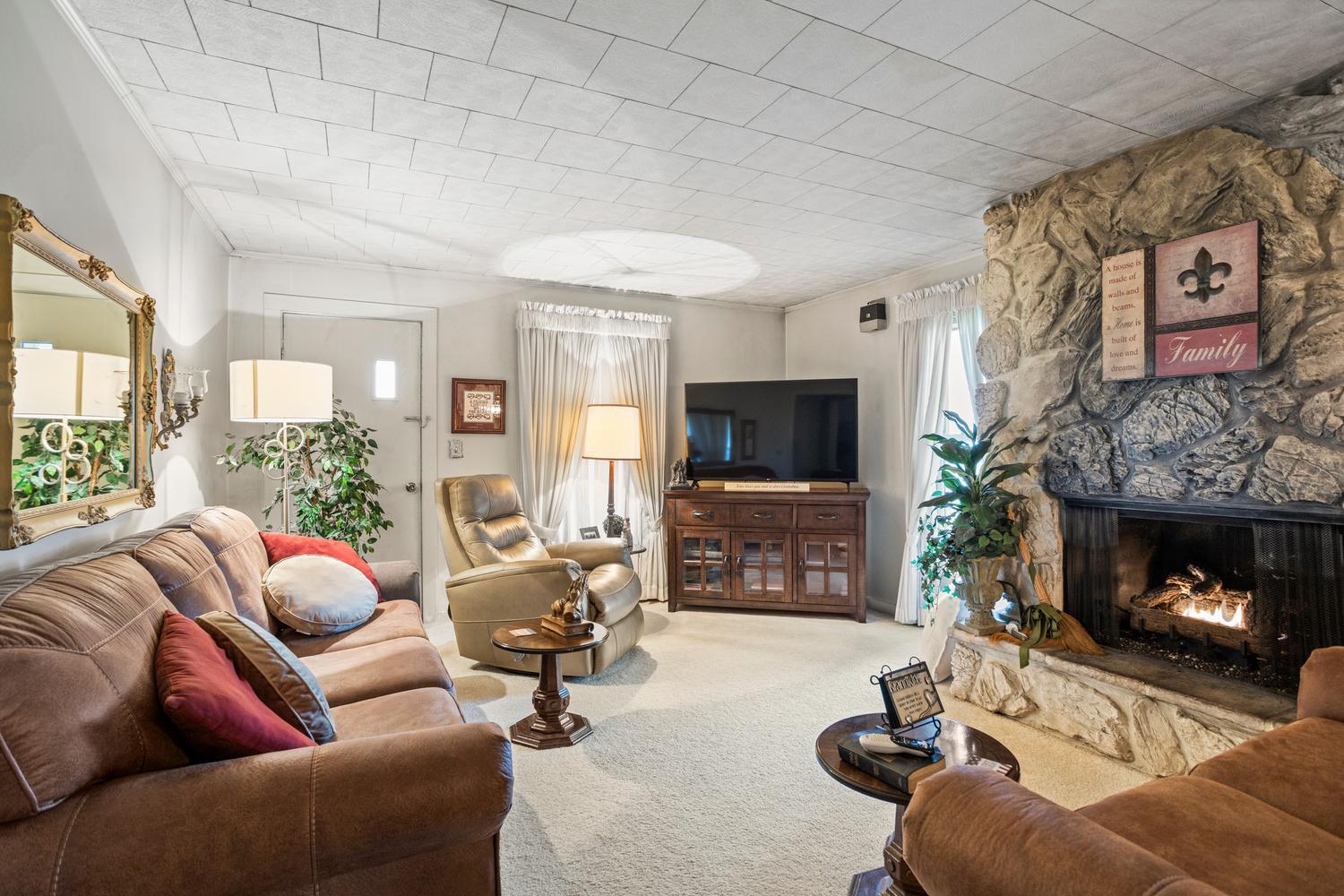 4520 North 600 East Road Sidell, IL 61876 - Photo 15 of 31 a living room with furniture a flat screen tv and a fireplace