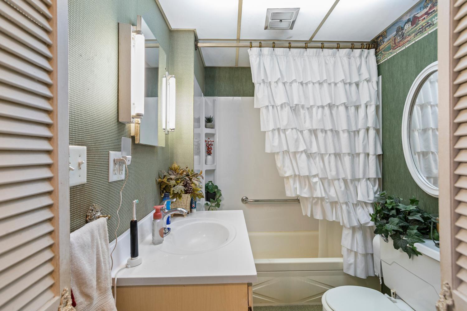 4520 North 600 East Road Sidell, IL 61876 - Photo 26 of 31 a bathroom with a sink toilet and shower