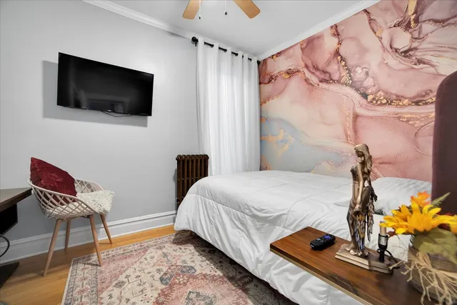 a bedroom with a bed and a flat screen tv