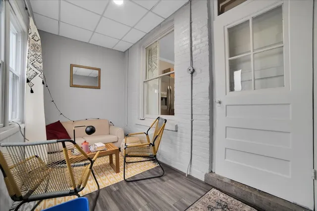 a dining room with furniture and wooden floor