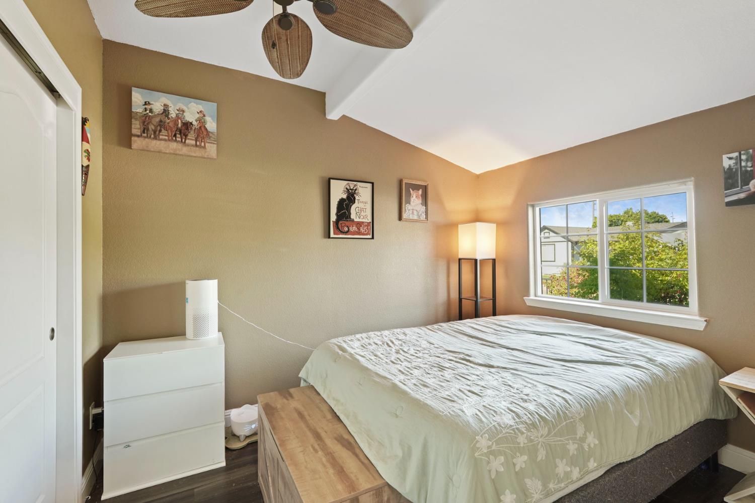 223 Rush Street Lodi, CA 95240 - Photo 11 of 21 a bedroom with a bed and dresser with mirror