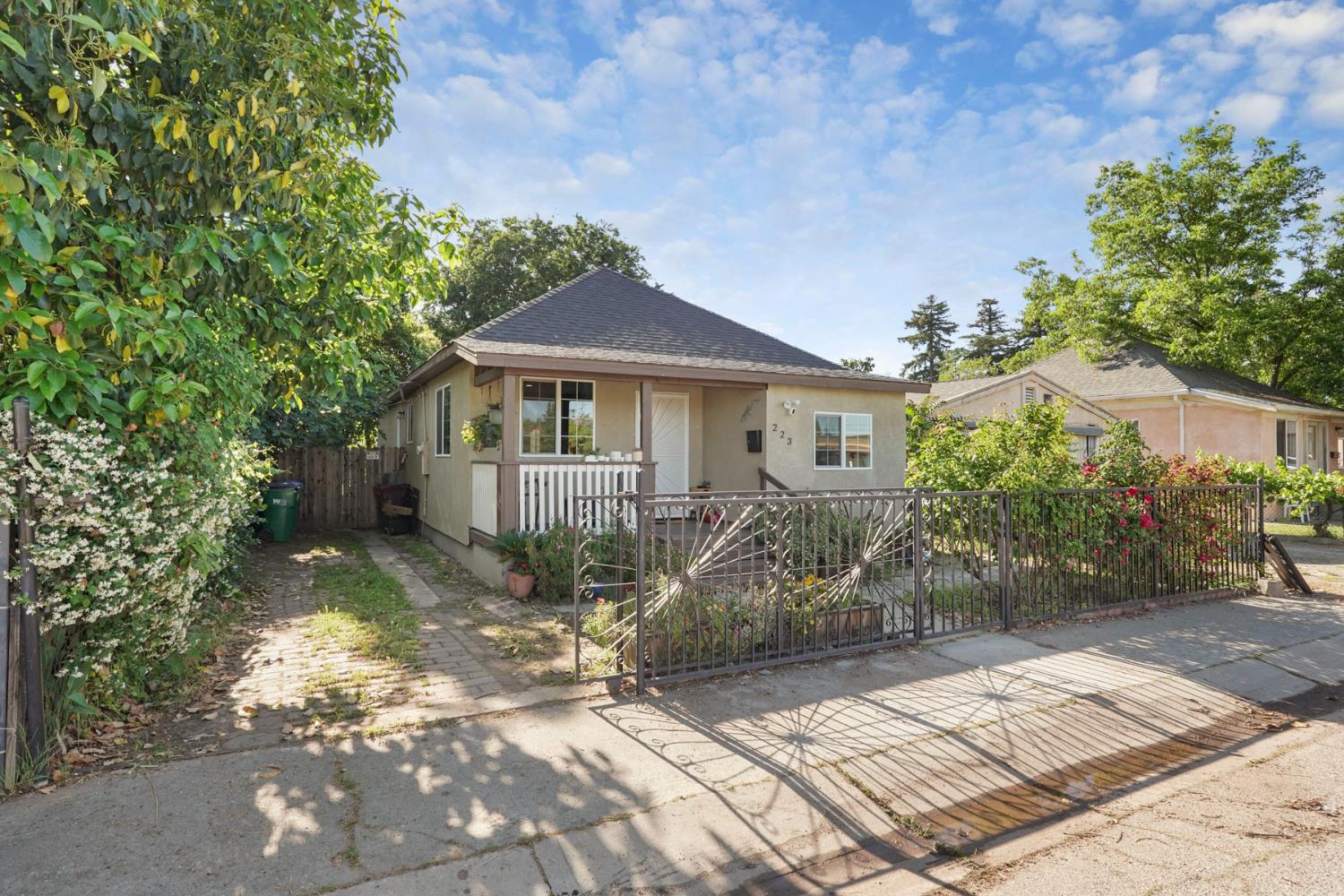 223 Rush Street Lodi, CA 95240 - Photo 2 of 21 a front view of a house with a garden