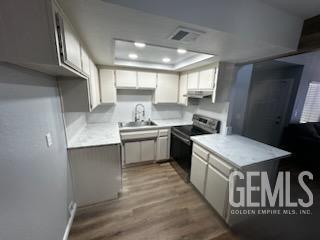 Undisclosed Address Bakersfield, CA 93309 - Photo 5 of 29 a kitchen that has a lot of cabinets in it
