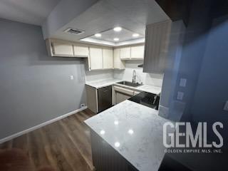 Undisclosed Address Bakersfield, CA 93309 - Photo 6 of 29 a kitchen with a sink a stove and cabinets