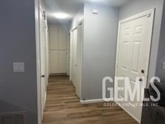 Undisclosed Address Bakersfield, CA 93309 - Photo 10 of 29 a view of a hallway with wooden floor and a livingroom