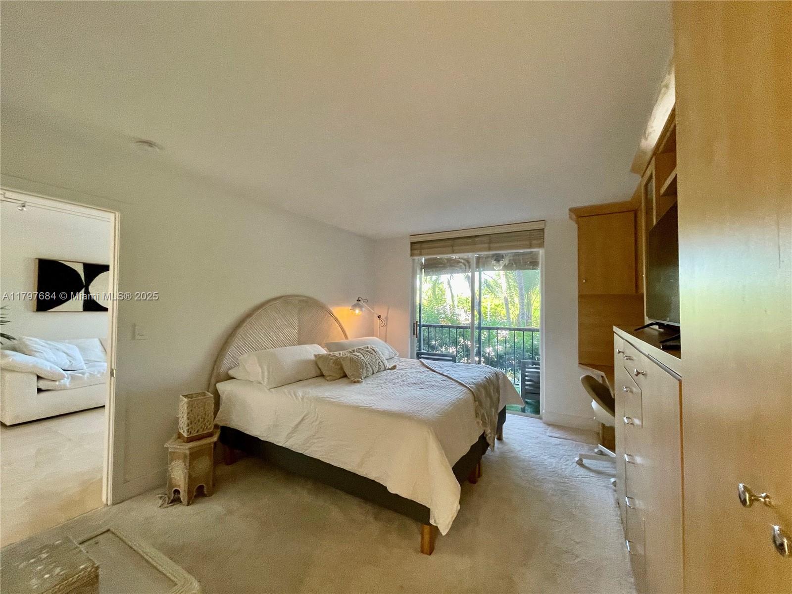 55 Ocean Ln Drive, Unit 2030 Key Biscayne, FL 33149 - Photo 11 of 19 a spacious bedroom with a bed and wooden floor