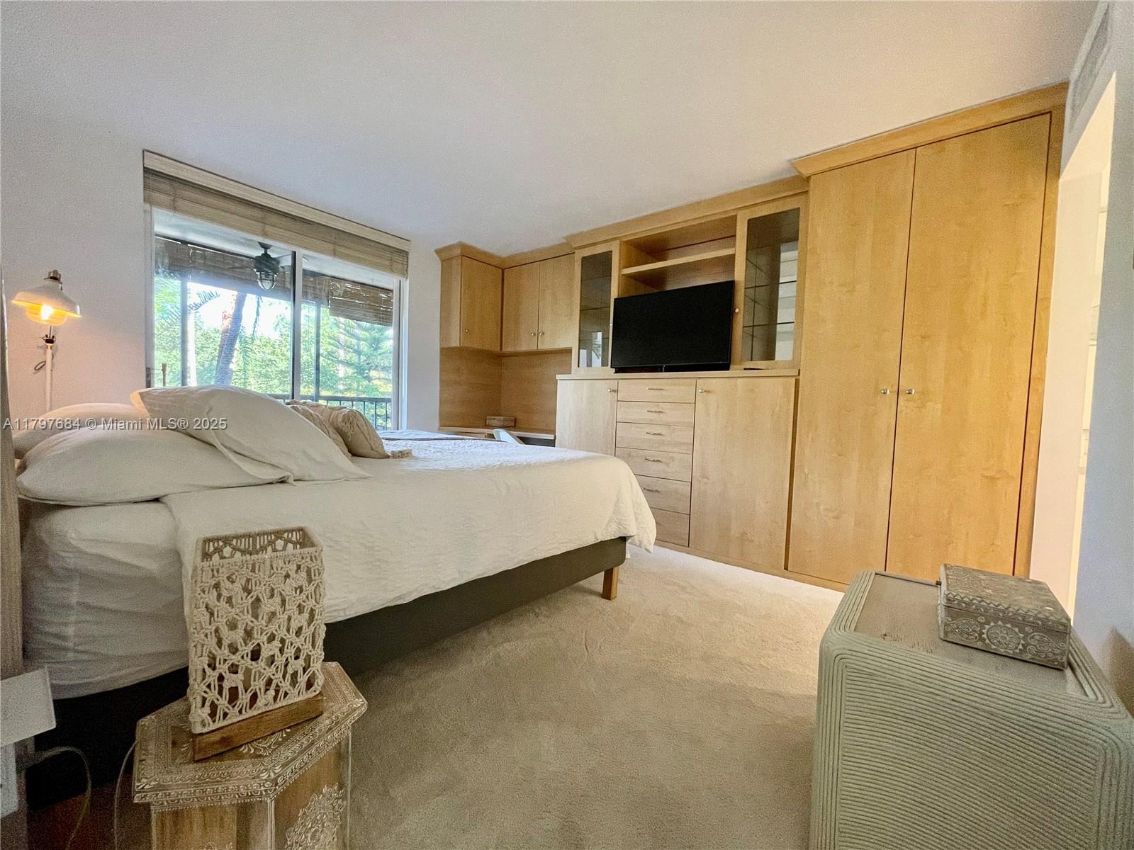 55 Ocean Ln Drive, Unit 2030 Key Biscayne, FL 33149 - Photo 12 of 19 a bedroom with a bed and a television